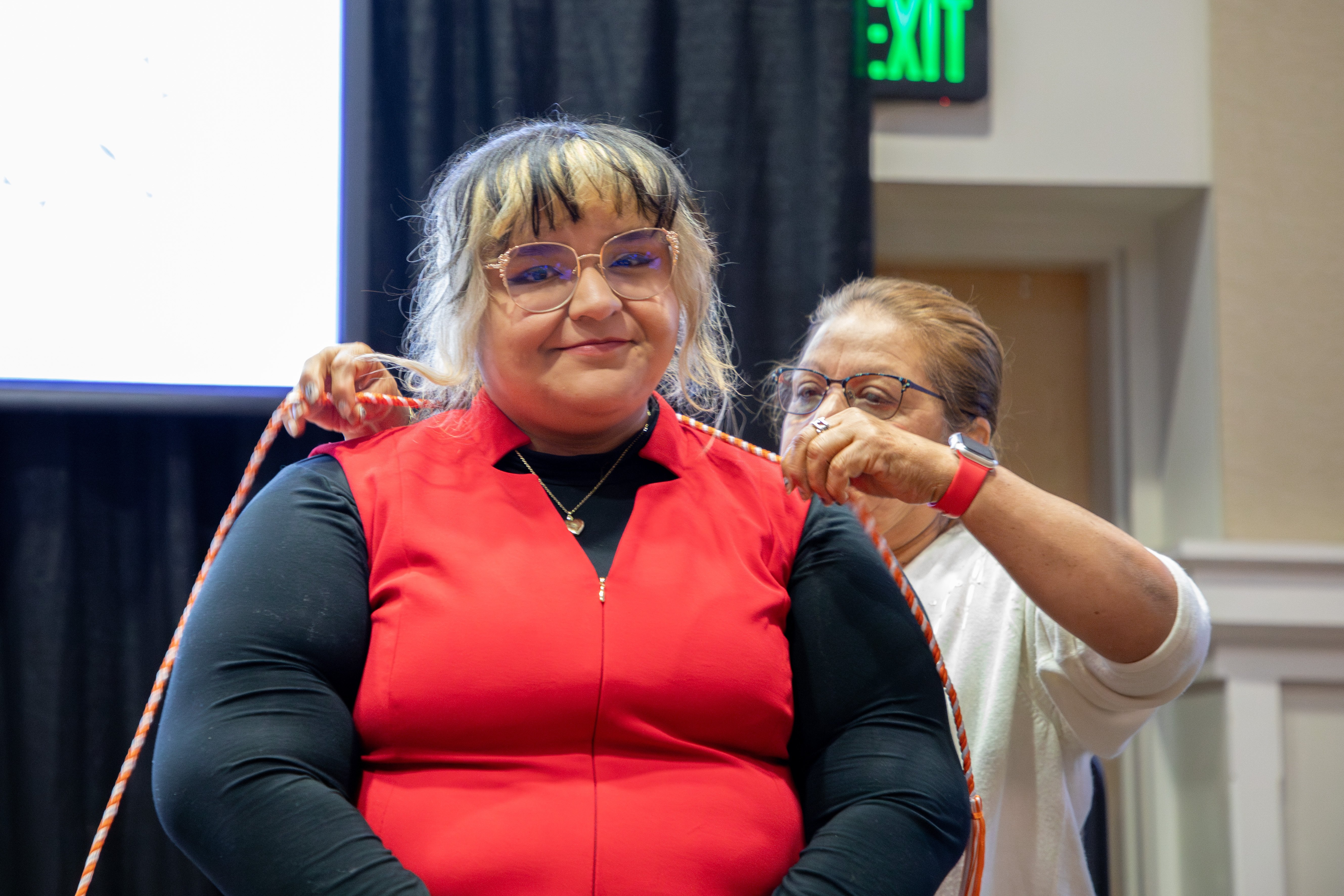 Clayton state chords being places on a student by staff.