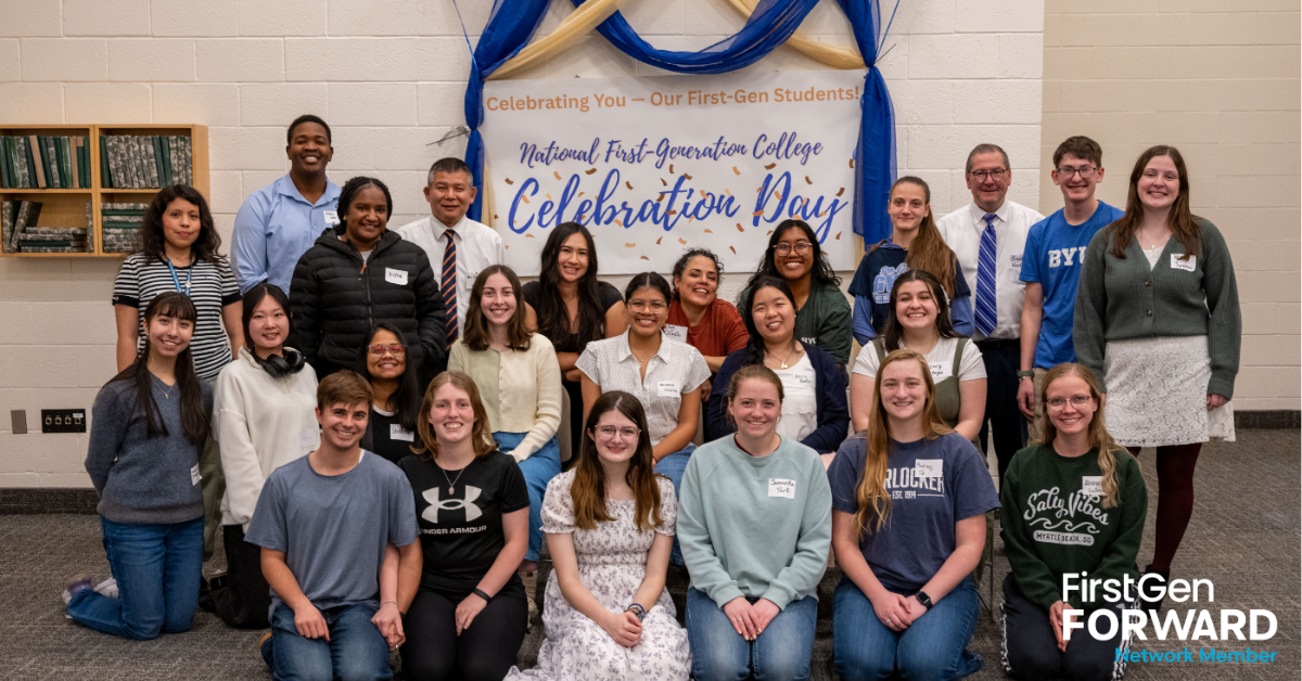 BYU Idaho Students and Staff infront of a celebration day banner.