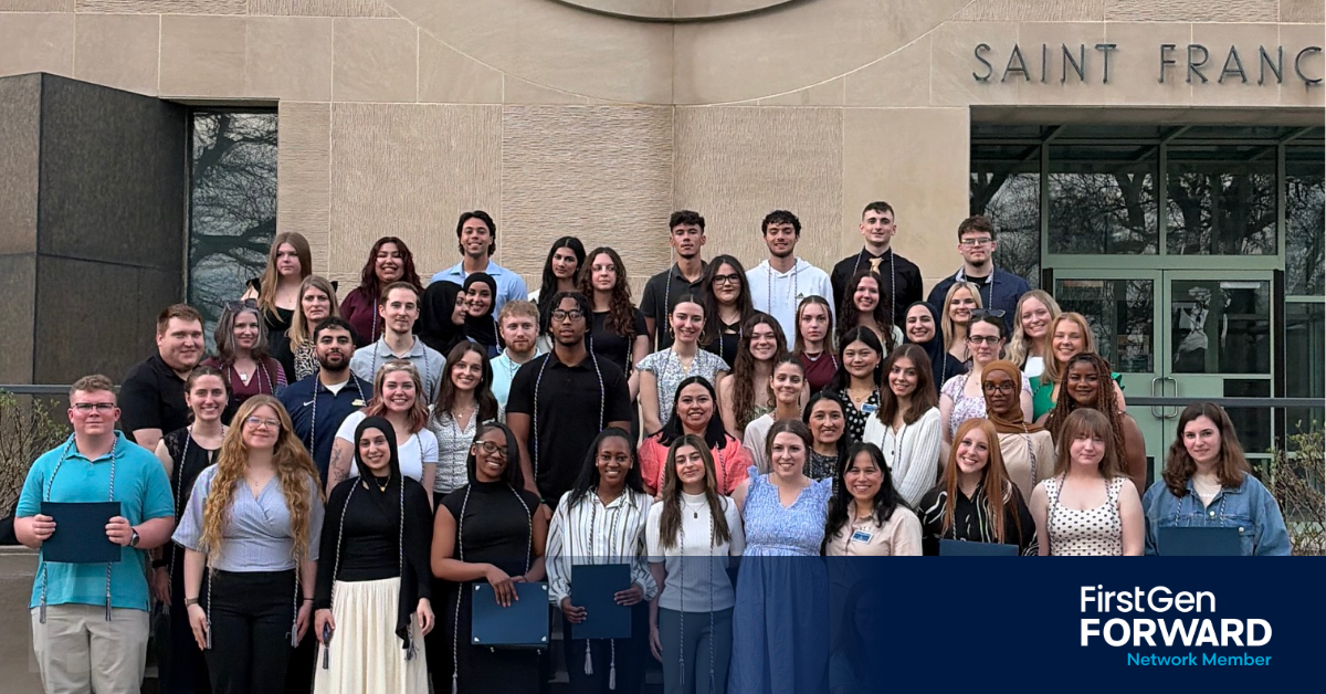 Students who are a group of diverse backgrounds standing in front of building saying Chapel, to showcases their Tri Alpha Honor Society cords with smiles on their faces.