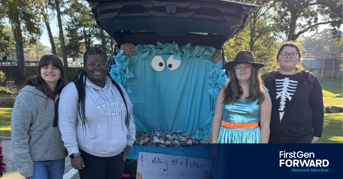 NextGen Navigators students take part in a Trunk or Treat event for the campus pre-school, standing in front of a decorated trunk and distributing treats.